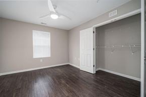 Charlotte apartment for rent - an empty bedroom with a closet and a ceiling fan