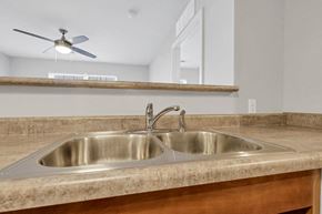 Columbus apartment for rent - a kitchen with a sink and a ceiling fan