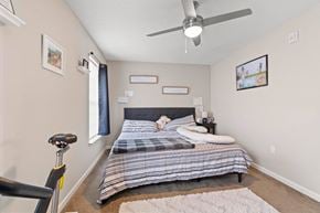 Cedar Rapids apartment for rent - a bedroom with a bed and a ceiling fan