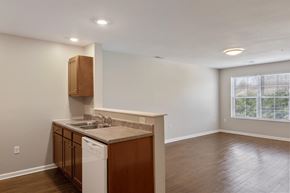 Hopkinsville apartment for rent - A kitchen with a white dishwasher and wooden cabinets.