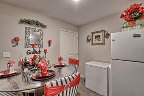 Denmark apartment for rent - a kitchen and dining room with a table and refrigerator