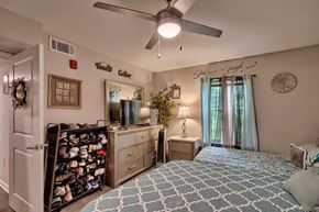 Denmark apartment for rent - a bedroom with a large bed and a ceiling fan