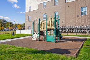 Des Moines apartment for rent - A playground with a green slide and a white slide.