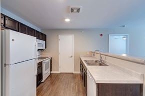 Indianapolis apartment for rent - a kitchen with a white refrigerator freezer next to a stove top oven