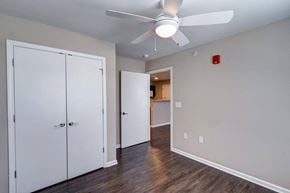 Indianapolis apartment for rent - a bedroom with a ceiling fan and a door to a bathroom