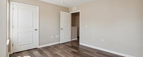 Pontiac apartment for rent - a bedroom with two doors and a bathroom in the background