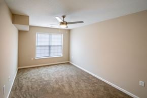 Cedar Rapids townhouse for rent - an empty living room with a ceiling fan and a window