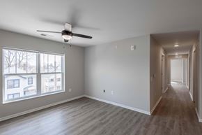Columbus apartment for rent - A spacious room with a ceiling fan and a long hallway.
