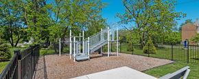 Pontiac apartment for rent - a playground with a slide and monkey bars at the preserve at great pond apartments in windsor