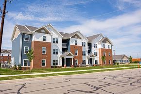 Columbus apartment for rent - A row of houses with a blue sky in the background.