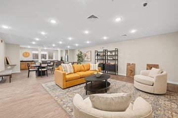 Cranberry Twp apartment for rent - A living room with a yellow couch and a coffee table.
