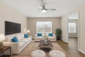 Columbus apartment for rent - A living room with a white couch, a coffee table, and a ceiling fan.