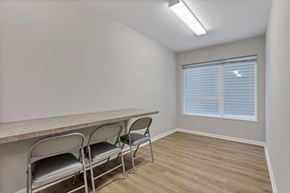 Columbus apartment for rent - a dining room with a long table and chairs in front of a window
