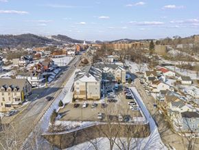 Waynesburg apartment for rent - A small town with a church in the background and a parking lot in the foreground.