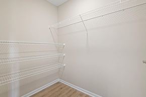 Athens apartment for rent - the closet in the bedroom of a home with white walls and