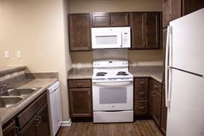 Atlanta apartment for rent - A kitchen with a white stove and a white refrigerator.