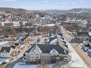 Waynesburg apartment for rent - A small town with apartment buildings and houses with snow on the ground.