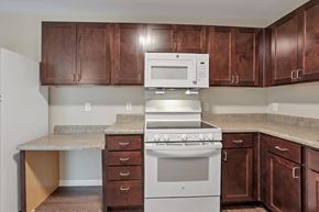 Columbus apartment for rent - a kitchen with white appliances and wooden cabinets