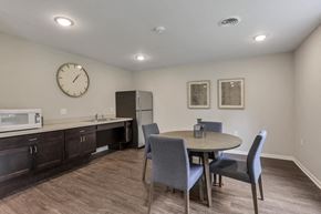 Columbus apartment for rent - a dining room with a table and chairs and a refrigerator and microwave
