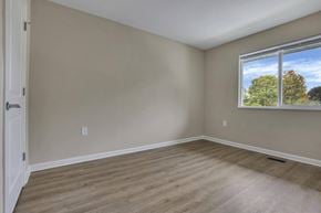 Barnesville apartment for rent - A room with a window showing trees and sky outside.