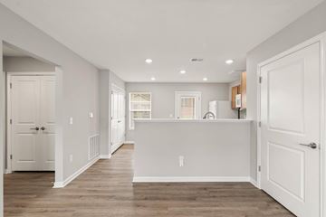Sellersburg apartment for rent - A spacious kitchen with white cabinets and a large island.