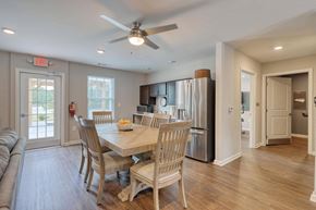 Calabash apartment for rent - a dining room and kitchen area with a table and chairs and a ceiling fan
