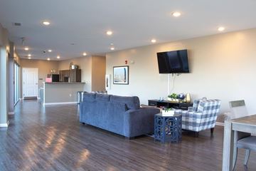 Atlanta apartment for rent - A living room with a grey couch and a wooden floor.