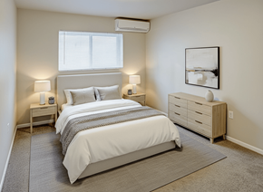 Cincinnati apartment for rent - A bedroom with a large bed and a nightstand with a lamp.