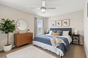 Cedar Rapids apartment for rent - A bedroom with a bed, dresser, and ceiling fan.