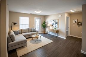 Cedar Rapids townhouse for rent - A living room with a grey couch, a coffee table, and a plant.