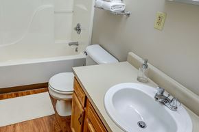 London apartment for rent - A white toilet sits next to a white sink in a bathroom.