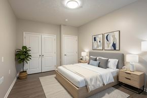 Athens apartment for rent - A bedroom with a bed, nightstand, and two framed pictures on the wall.
