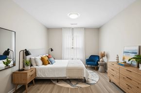 Marquette apartment for rent - A bedroom with a bed, chair, and a dresser.