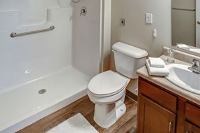 Shelbyville apartment for rent - A white toilet sits next to a white sink in a bathroom.