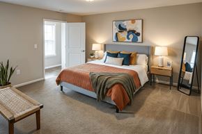 Shelbyville apartment for rent - A bedroom with a bed, nightstands, and a mirror.