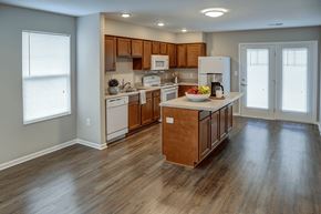 Shelbyville apartment for rent - A kitchen with wooden cabinets and a white refrigerator.