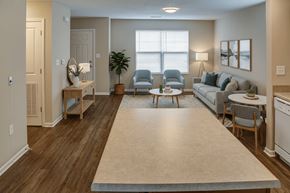 Shelbyville apartment for rent - A living room with a couch, chairs, and a table.