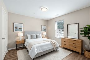 Grand Rapids apartment for rent - A bedroom with a large bed, two nightstands, and a window.