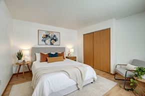 Wintersville apartment for rent - A bedroom with a bed, a chair, and a painting on the wall.