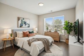 Wilton apartment for rent - A bedroom with a large bed and a painting on the wall.