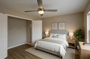 Columbus apartment for rent - A bedroom with a bed, nightstand, and a ceiling fan.