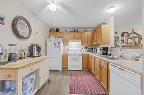 Cadiz apartment for rent - a kitchen with white appliances and wooden cabinets