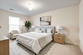 Goose Creek apartment for rent - A bedroom with a large bed and a chair.