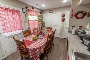 Kingstree apartment for rent - a kitchen with a table and chairs with a red and white checkered tablecloth