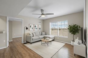 Columbus apartment for rent - A living room with a grey couch, a coffee table, and a ceiling fan.