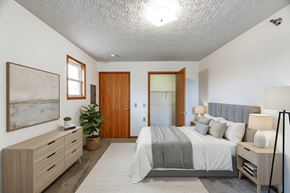Upper Sandusky apartment for rent - A bedroom with a bed, nightstand, and a painting on the wall.