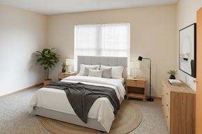 Piketon apartment for rent - A bedroom with a large bed and a plant on the side table.