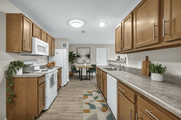 Cleveland apartment for rent - A kitchen with white appliances and wooden cabinets.