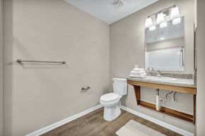Cleveland apartment for rent - A bathroom with a toilet, sink, and mirror.