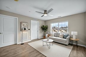 Cleveland apartment for rent - A living room with a white couch, a coffee table, and a ceiling fan.